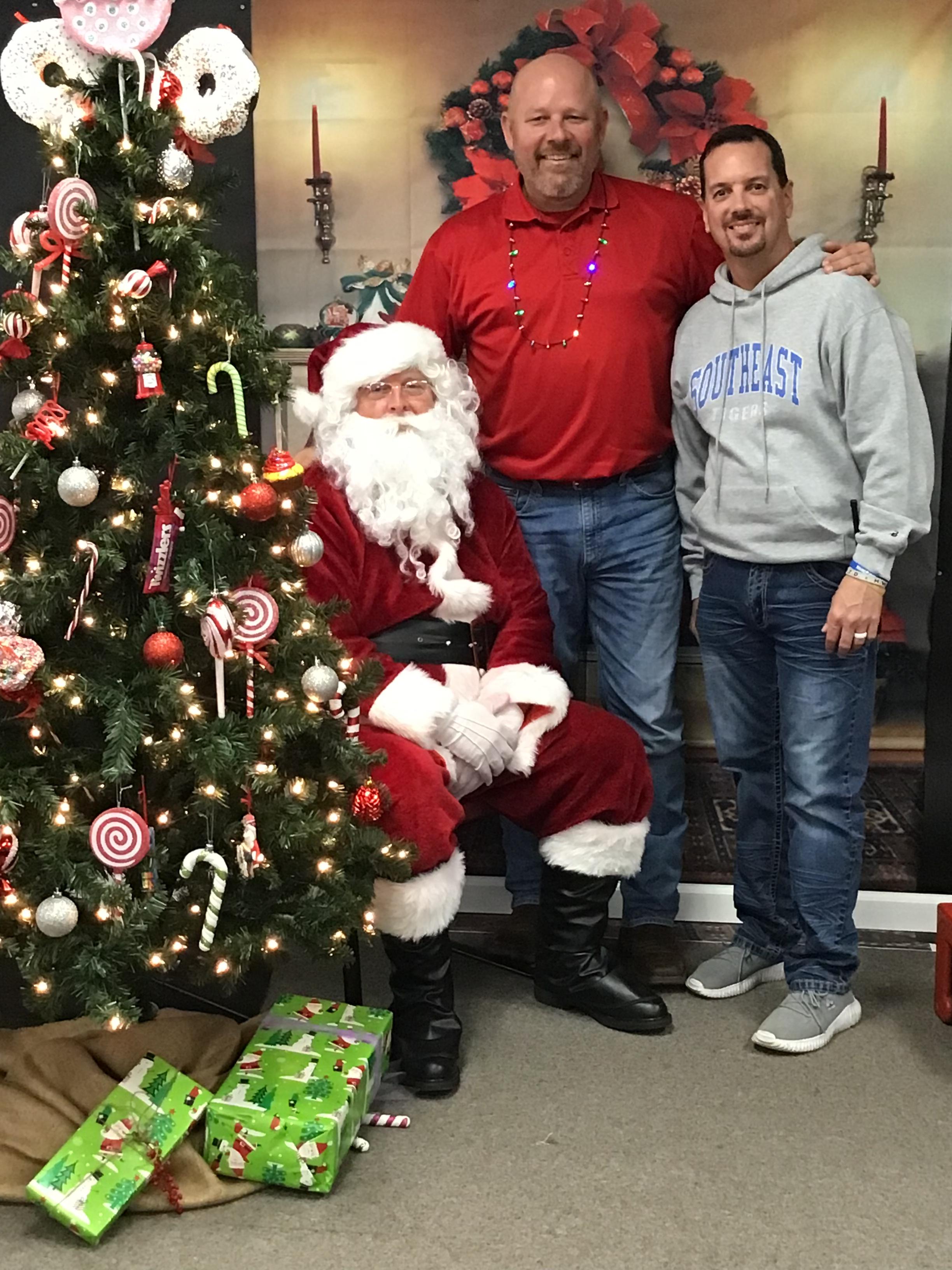 Mr. Powell and Dr. Holifield with Santa 